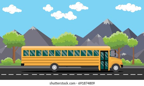 school bus yellow on road with tree and mountain as background