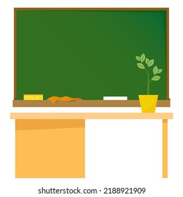 School green board with chalk and rulers and table in front