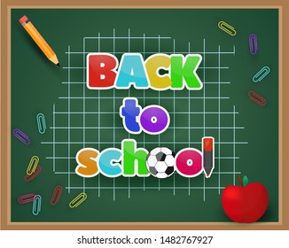 School green chalkboard with back to school text, pencil clips and red apple on checkered background.