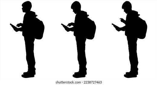 School student with a backpack, and a phone. Young teenagers scroll through smartphones. Teenagers use mobile cell phones together. Communicating online. Gadget addiction, communication technology