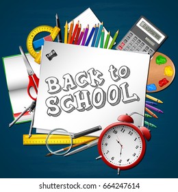 School supplies on blackboard background