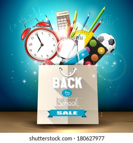 School supplies in a shopping bag - back to school sale concept