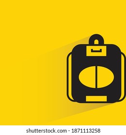 schoolbag with shadow on yellow background