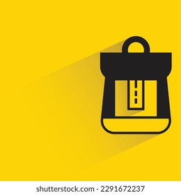 schoolbag with shadow on yellow background
