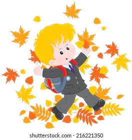 Schoolboy with autumn leaves