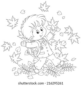 Schoolboy with autumn leaves