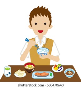 Schoolboy eating Japanese breakfast