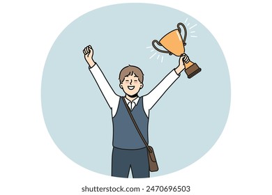 Schoolboy with golden cup rejoices at award received for winning school mathematics olympiad. Schoolboy with trophy makes winning gesture demonstrating leadership qualities while receiving education