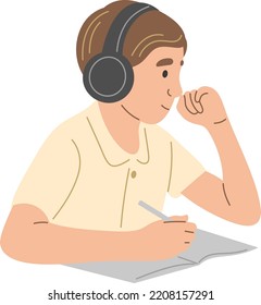 A schoolboy with headphones writes in a notebook.