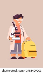 schoolboy holding microscope smart student making chemical experiments vertical