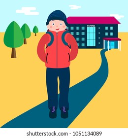 Schoolboy teen with bag standing near the school