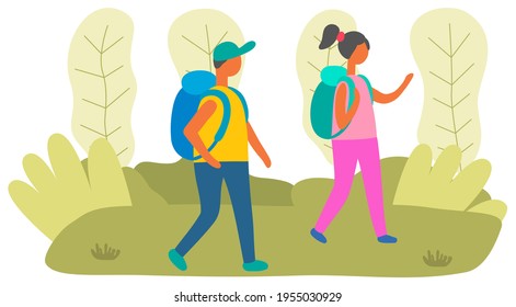 Schoolchildren with backpacks are walking in park. Students spend time together in nature