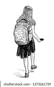 A schoolgirl with a smartphone goes to school