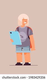 schoolgirl using tablet pc smiling girl with gadget vertical