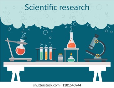 Scientific research, chemistry, laboratory table. Microscope and test tubes with space for text