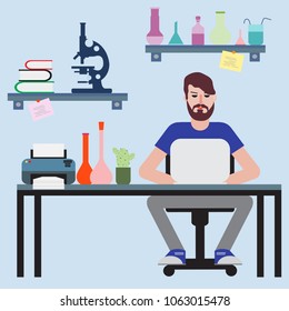 Scientist. Man sitting at table in his office and working on laptop.Workspace.