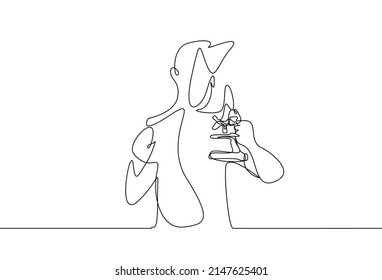 a scientist student holding a microscope