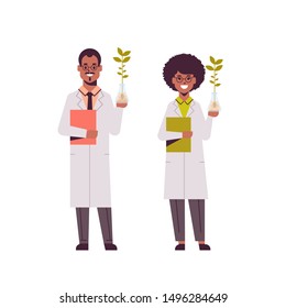 scientists couple examining plant sample in test tubes african american man woman in uniform making experiments in genetic lab research science chemical concept full length flat