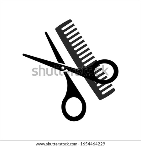 Scissors and comb on a white background