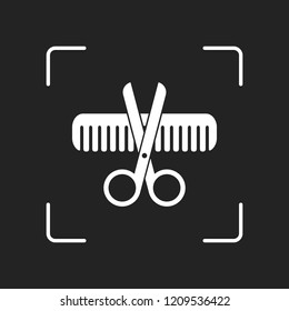 Scissors and hair brush. Crossed tools of barber. White object in camera autofocus on dark background