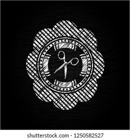 scissors icon drawn on blackboard
