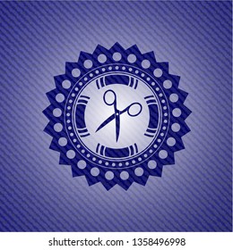 scissors icon inside badge with denim background