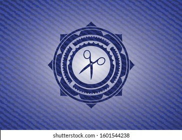 scissors icon inside badge with jean texture