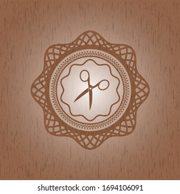 scissors icon inside badge with wood background
