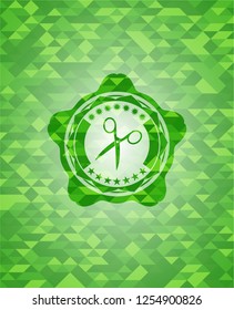 scissors icon inside green emblem with mosaic background