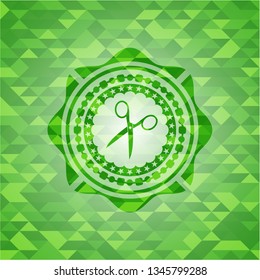 scissors icon inside green mosaic emblem