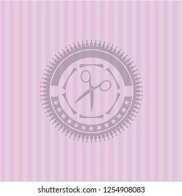 scissors icon inside pink emblem