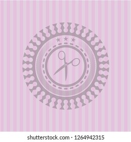 scissors icon inside pink emblem