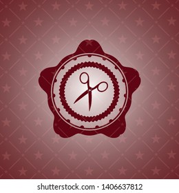 scissors icon inside red emblem