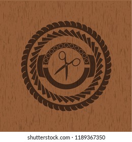 scissors icon inside retro wood emblem