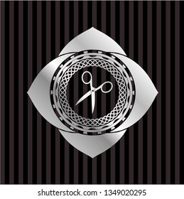 scissors icon inside silvery emblem