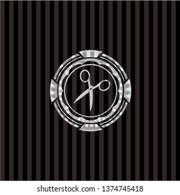 scissors icon inside silvery emblem