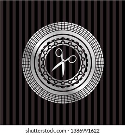 scissors icon inside silvery emblem