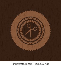scissors icon inside vintage wooden emblem
