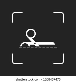 scissors icon. White object in camera autofocus on dark background
