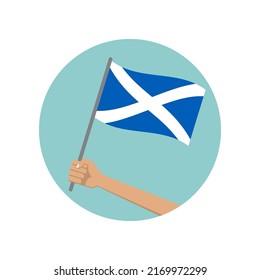 Scotland waving flag circle icon. Hand holding Scottish flag. National symbol. Vector illustration. 