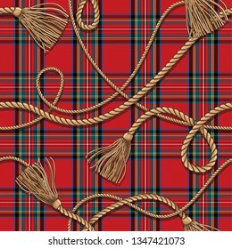 Scottish-style checkered pattern with golden weaves of ropes and tassels. Tartan. Wool red fabric.