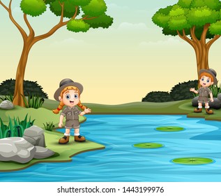 Scout boy and girl talking by the river