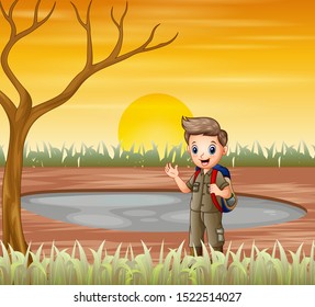 The scout boy standing under a dry tree