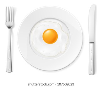 Scrambled egg in a bowl with a fork and knife