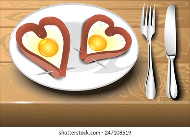Scrambled eggs with sausage in a heart shape on a white plate