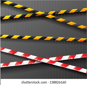 Scratched danger tapes on dark background. Vector illustration.