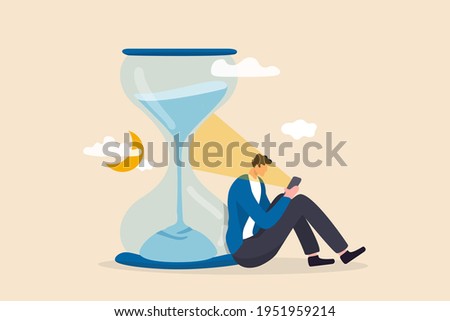 Screen time, doom scrolling or wasted time using smartphone, staying late night with mobile addiction concept, exhausted man sitting with sandglass using smartphone with bright light on his face.