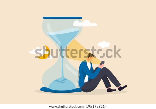 Screen time, doom scrolling or wasted time using
smartphone, staying late night with mobile addiction concept,
exhausted man sitting with sandglass using smartphone with bright
light on his face.
