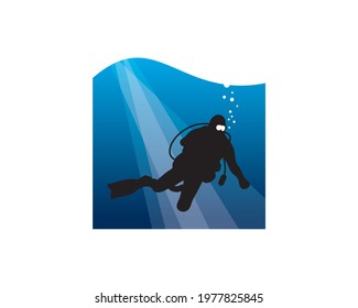 scuba diver diving in deep sea blue with sun rays passing	