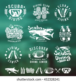 Scuba diving emblems, labels and design elements. White print on  marine blurred background